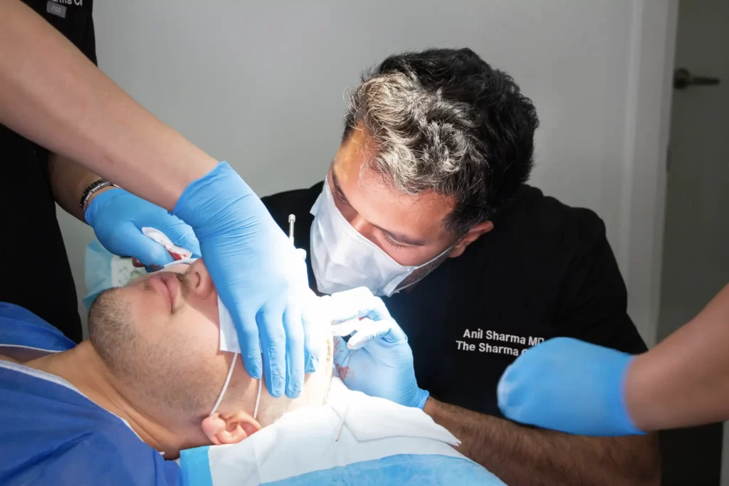 Dr. Anil Sharma (mole removal specialist in Ottawa) performing a surgery