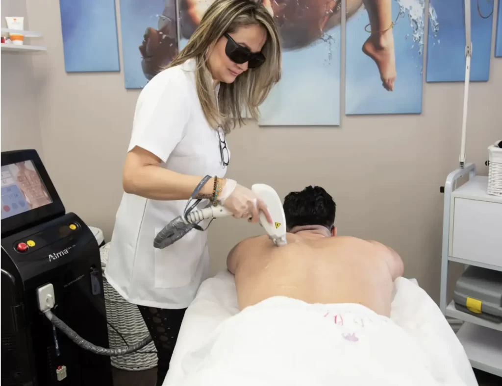 Akhlas performing laser hair removal treatment on her client
